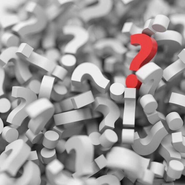 One red question mark sits on top of a huge pile of white question marks.